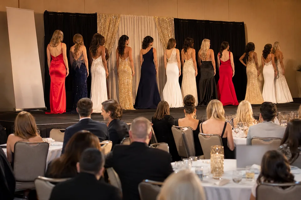 State pageant evening in a hotel ballroom with a blank sponsor banner stand